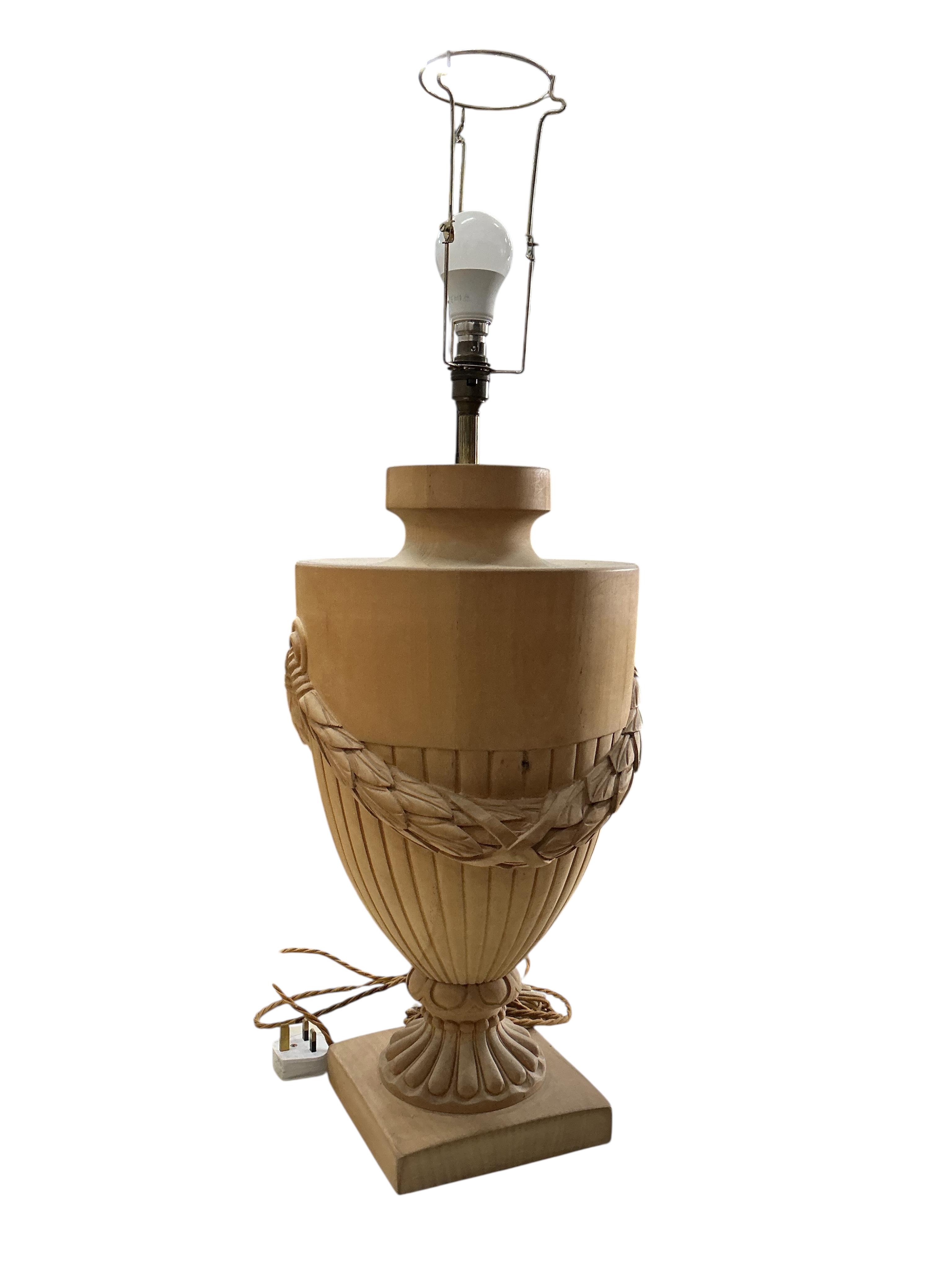 A pair of beech campana urn shaped lamps with shades, height including shades 90cm, Provenance: The late Kenneth Turner (1936-2025), celebrity florist, designer and perfume retailer, he received the Royal Warrant from th